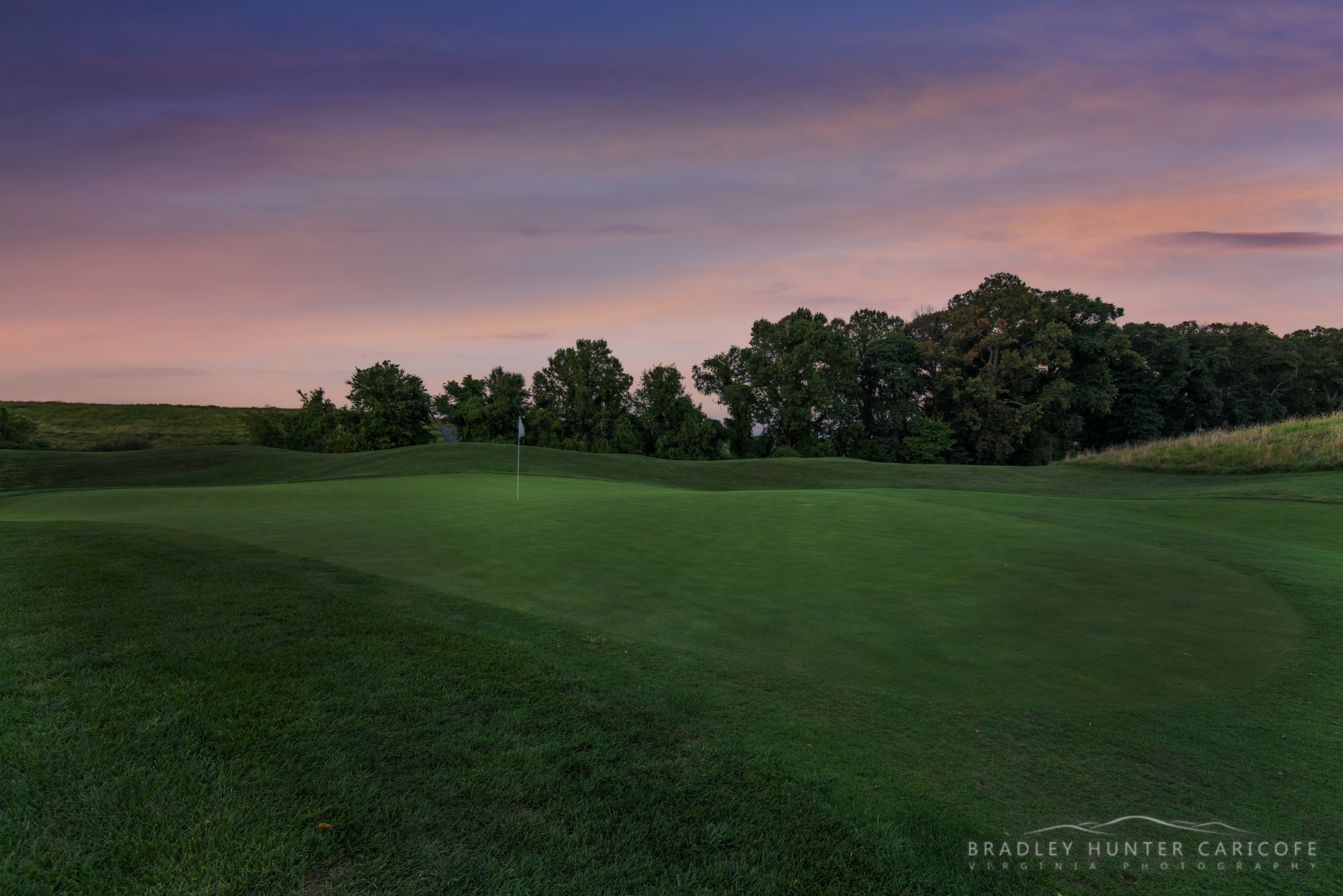 golf course green at sunset